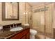 Bathroom with granite countertop, wood vanity, and a shower with glass enclosure at 14422 S 24Th Pl, Phoenix, AZ 85048