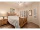 Well-lit bedroom with a double bed and plantation shutters at 14422 S 24Th Pl, Phoenix, AZ 85048