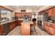 Modern kitchen with island, stainless steel appliances, and wood cabinets at 14422 S 24Th Pl, Phoenix, AZ 85048