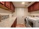 Laundry room with marble countertop, wooden cabinets, and washer/dryer at 14422 S 24Th Pl, Phoenix, AZ 85048