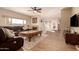 Spacious living room featuring hardwood floors, a fireplace, and ample natural light at 14422 S 24Th Pl, Phoenix, AZ 85048