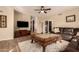 Light and airy living room with hardwood floors and a large TV at 14422 S 24Th Pl, Phoenix, AZ 85048