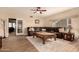 Living room with L-shaped sectional sofa, coffee table, and large windows at 14422 S 24Th Pl, Phoenix, AZ 85048