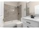 Modern bathroom featuring a white vanity and gray tile at 16008 N Hollyhock St, Surprise, AZ 85378