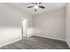 Simple bedroom with wood-look floors and bathroom access at 16008 N Hollyhock St, Surprise, AZ 85378