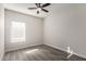 Second bedroom with neutral color palette and ceiling fan at 16008 N Hollyhock St, Surprise, AZ 85378