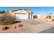 House exterior with a white garage door and desert landscaping at 16008 N Hollyhock St, Surprise, AZ 85378