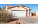 House exterior with a white garage door and desert landscaping at 16008 N Hollyhock St, Surprise, AZ 85378