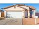 House exterior features a white garage door and desert landscaping at 16008 N Hollyhock St, Surprise, AZ 85378