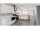 Modern kitchen with white cabinets and stainless steel appliances at 16008 N Hollyhock St, Surprise, AZ 85378