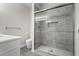 Modern shower with glass enclosure and grey tile at 16008 N Hollyhock St, Surprise, AZ 85378