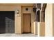 Home's entryway with wood door and access to garage at 16410 S 12Th St # 206, Phoenix, AZ 85048