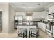 Modern kitchen with white cabinets, granite counters and island at 16410 S 12Th St # 206, Phoenix, AZ 85048