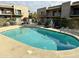 Relaxing kidney-shaped community pool with patio chairs at 16616 E Palisades Blvd # 206, Fountain Hills, AZ 85268