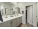 Bathroom with double sinks, a large mirror, and modern fixtures at 16790 W Molly Ln, Surprise, AZ 85387