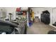 Well-organized garage with ample storage and a gray sports car at 16790 W Molly Ln, Surprise, AZ 85387