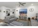 Comfortable living room with a large-screen TV and neutral tones, and a ceiling fan at 16790 W Molly Ln, Surprise, AZ 85387