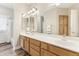 Well-lit bathroom with double vanity, wood look floors, and updated fixtures at 1743 E Menlo St, Mesa, AZ 85203