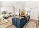 Open-concept kitchen features a large center island with dark blue cabinets, a sink, and stainless steel appliances at 1743 E Menlo St, Mesa, AZ 85203