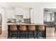 Gourmet kitchen with modern appliances, a large center island, and stylish bar stools at 1743 E Menlo St, Mesa, AZ 85203