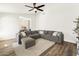 Spacious living room features a comfortable sectional sofa, neutral rug, and wood flooring, creating a relaxing space at 1743 E Menlo St, Mesa, AZ 85203