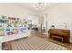 Open living space with bookshelf, piano, and cozy seating area, with ample natural light at 1743 E Menlo St, Mesa, AZ 85203