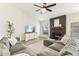 Cozy living room with a fireplace, large sectional sofa, ceiling fan, and neutral decor creating a warm atmosphere at 1743 E Menlo St, Mesa, AZ 85203