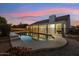 Backyard pool with safety fence, patio, and covered outdoor area enhances this home's outdoor living at 1743 E Menlo St, Mesa, AZ 85203