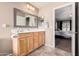 Bathroom with wood cabinets and a large mirror at 17774 W Watson Ln, Surprise, AZ 85388