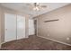 Bright bedroom with double door closet and carpet at 17774 W Watson Ln, Surprise, AZ 85388