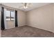 Bedroom with carpeted floor, ceiling fan, and window coverings at 17774 W Watson Ln, Surprise, AZ 85388