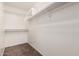 Large walk-in closet with shelving and hanging rods at 17774 W Watson Ln, Surprise, AZ 85388