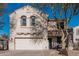 Two-story house with a white garage door and landscaping at 17774 W Watson Ln, Surprise, AZ 85388