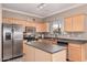 Kitchen with stainless steel appliances and an island at 17774 W Watson Ln, Surprise, AZ 85388