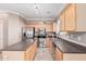 Kitchen with stainless steel appliances and an island at 17774 W Watson Ln, Surprise, AZ 85388