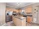 Kitchen with stainless steel appliances and an island at 17774 W Watson Ln, Surprise, AZ 85388