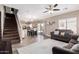 Open living room with a view of kitchen and staircase at 17774 W Watson Ln, Surprise, AZ 85388