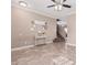 Living room with tiled floors, gray couches, and a ceiling fan at 17774 W Watson Ln, Surprise, AZ 85388