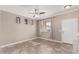 Bright living room with tiled floors and a ceiling fan at 17774 W Watson Ln, Surprise, AZ 85388