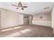 Open loft area with carpeted floor and ceiling fan at 17774 W Watson Ln, Surprise, AZ 85388