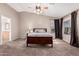 Main bedroom with carpeted floor, ceiling fan, and ensuite bathroom access at 17774 W Watson Ln, Surprise, AZ 85388