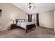 Main bedroom with dark wood furniture and ensuite bathroom at 17774 W Watson Ln, Surprise, AZ 85388