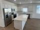 Modern kitchen featuring stainless steel appliances and an island at 17814 W Carol Ave, Waddell, AZ 85355