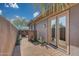 Private backyard access with tiled pathway and landscaping at 18007 W Ocotillo Ave, Goodyear, AZ 85338