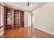 Well-lit bedroom with hardwood floors and built-in shelving at 18007 W Ocotillo Ave, Goodyear, AZ 85338