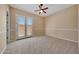 Spacious bedroom with carpet, ceiling fan and French doors at 18007 W Ocotillo Ave, Goodyear, AZ 85338