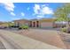 Single-story home with brick driveway and landscaping at 18007 W Ocotillo Ave, Goodyear, AZ 85338