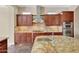 Elegant kitchen with granite countertops and a built-in oven at 18007 W Ocotillo Ave, Goodyear, AZ 85338