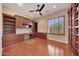 Home office with hardwood floors, built-in desk and shelving at 18007 W Ocotillo Ave, Goodyear, AZ 85338