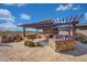 Built-in outdoor kitchen with pergola and seating at 18007 W Ocotillo Ave, Goodyear, AZ 85338